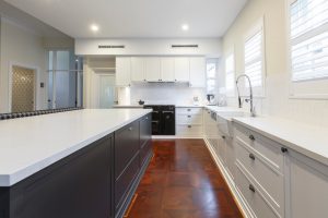 photo of renovated kitchen with white countertops 