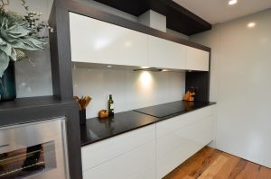photo of renovated kitchen with black countertops 